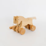 Handmade Wooden Pull-Along Horse Toy with a natural pine wood body, teak wood wheels, and a pull-along string, designed for kids aged 3+