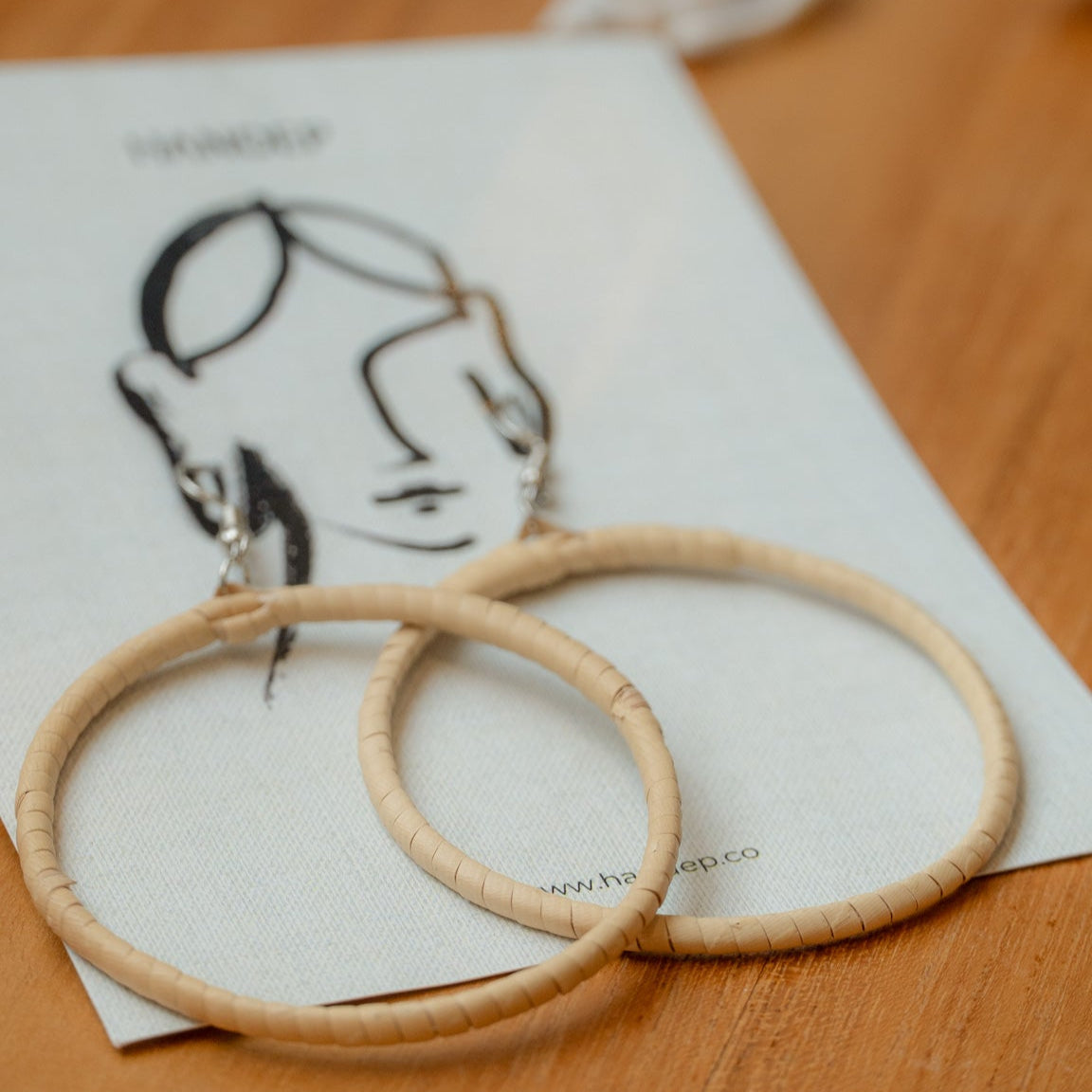 Diane Loop Round handwoven rattan earring in beige, an eco-friendly artisan accessory.