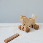 Handmade Wooden Pull-Along Horse Toy with a natural pine wood body, teak wood wheels, and a pull-along string, designed for kids aged 3+