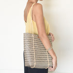 Anya Handwoven Rattan Shoulder Bag, a lightweight and durable summer bag crafted from natural rattan, featuring a stylish zigzag pattern and long handles, handwoven by women artisans in Borneo, Indonesia. Ideal for beach trips or as a work bag, capable of holding up to 3kg